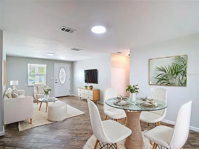 a view of a dining room with furniture and chandelier