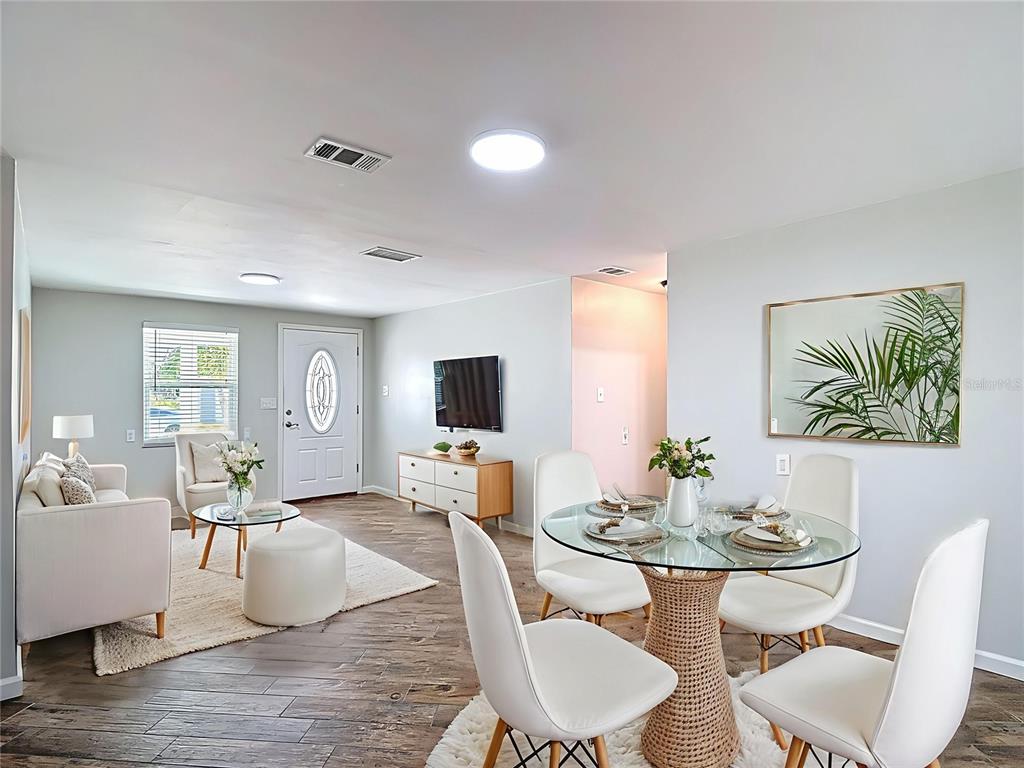 13607 Frances Avenue Hudson, FL 34667 - Photo 13 of 76 a living room with furniture kitchen view and a flat screen tv
