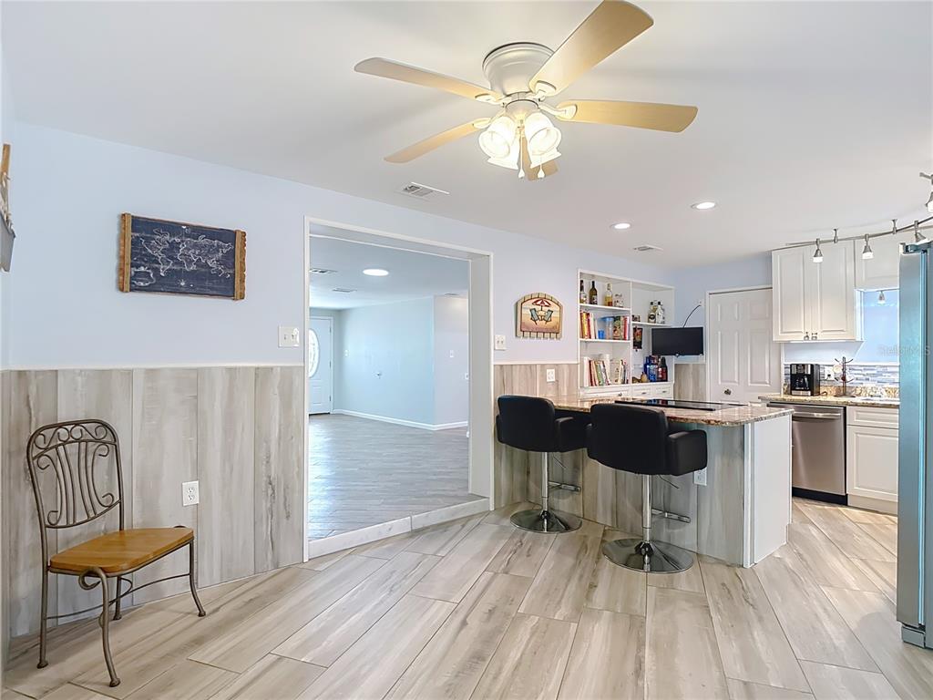 13607 Frances Avenue Hudson, FL 34667 - Photo 19 of 76 a view of a dining room with furniture and chandelier