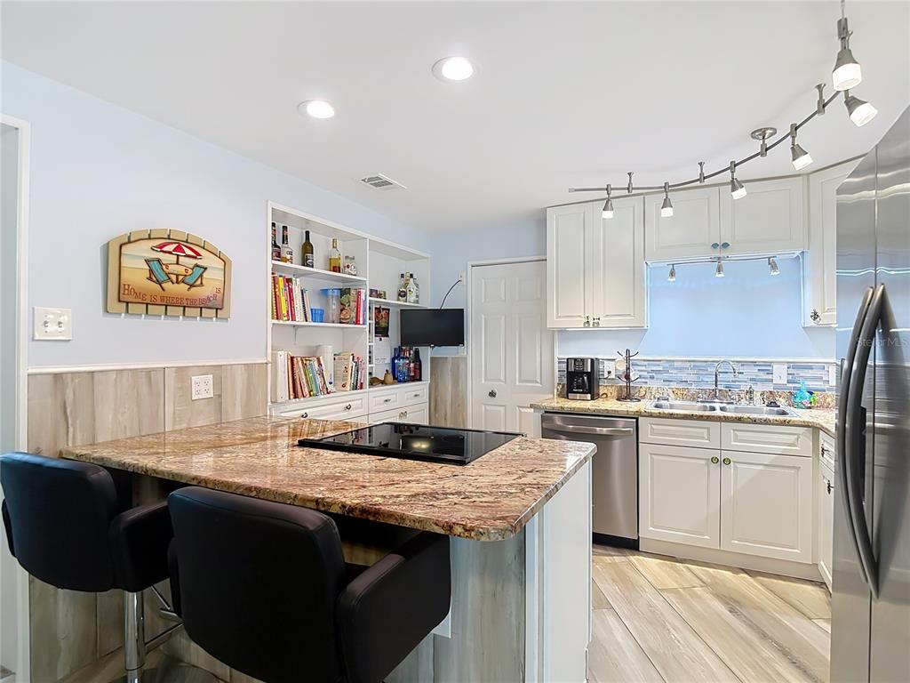 13607 Frances Avenue Hudson, FL 34667 - Photo 21 of 76 a kitchen with granite countertop a sink stove and cabinets