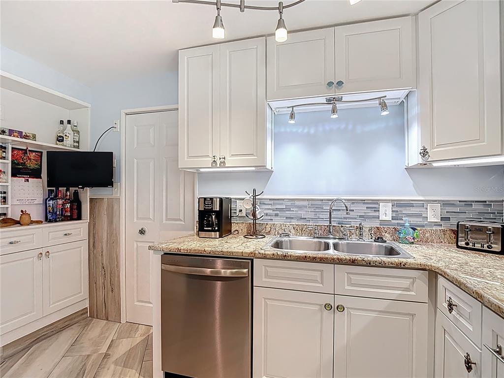 13607 Frances Avenue Hudson, FL 34667 - Photo 25 of 76 a kitchen with kitchen island granite countertop a sink a counter space appliances and cabinets