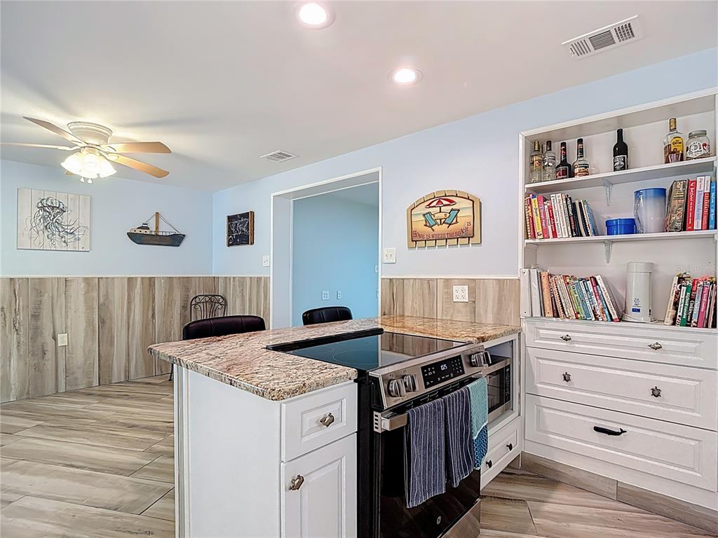 13607 Frances Avenue Hudson, FL 34667 - Photo 26 of 76 a kitchen with granite countertop a stove and a cabinets