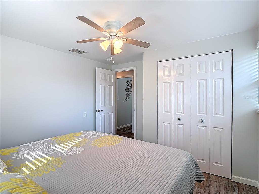 13607 Frances Avenue Hudson, FL 34667 - Photo 33 of 76 a bedroom with a bed and a chandelier