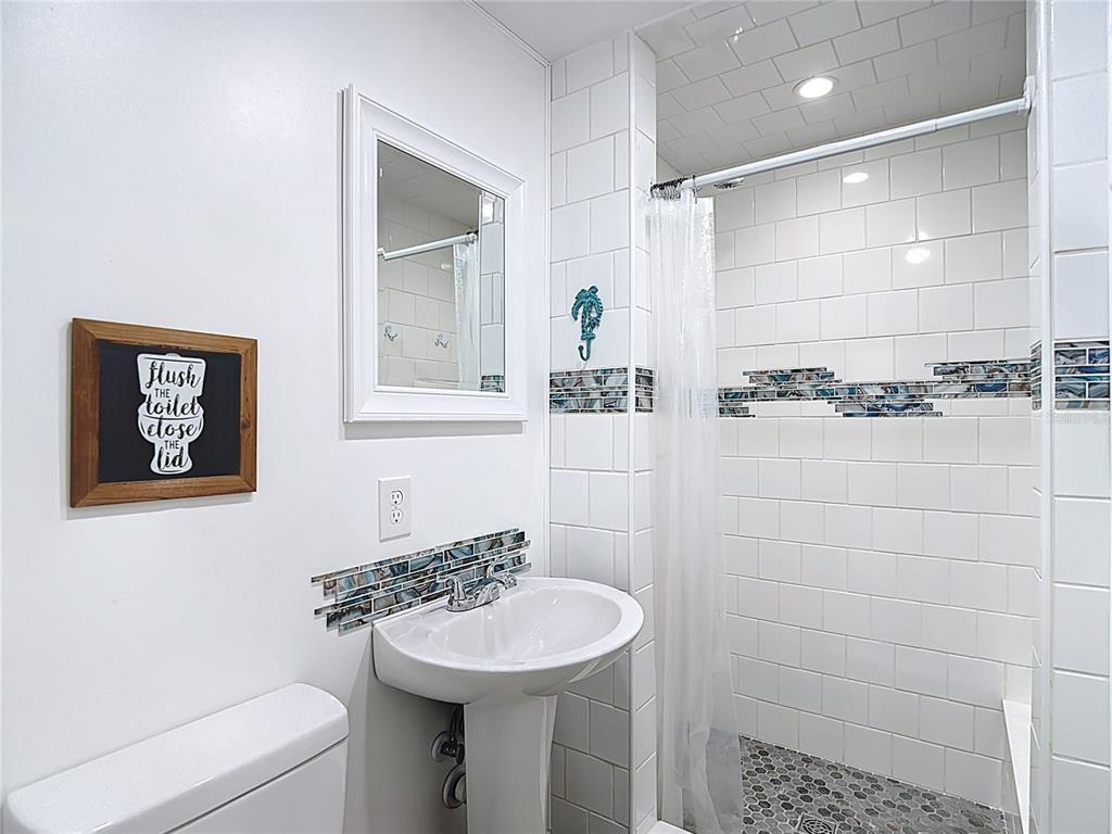 13607 Frances Avenue Hudson, FL 34667 - Photo 34 of 76 a bathroom with a sink toilet and shower