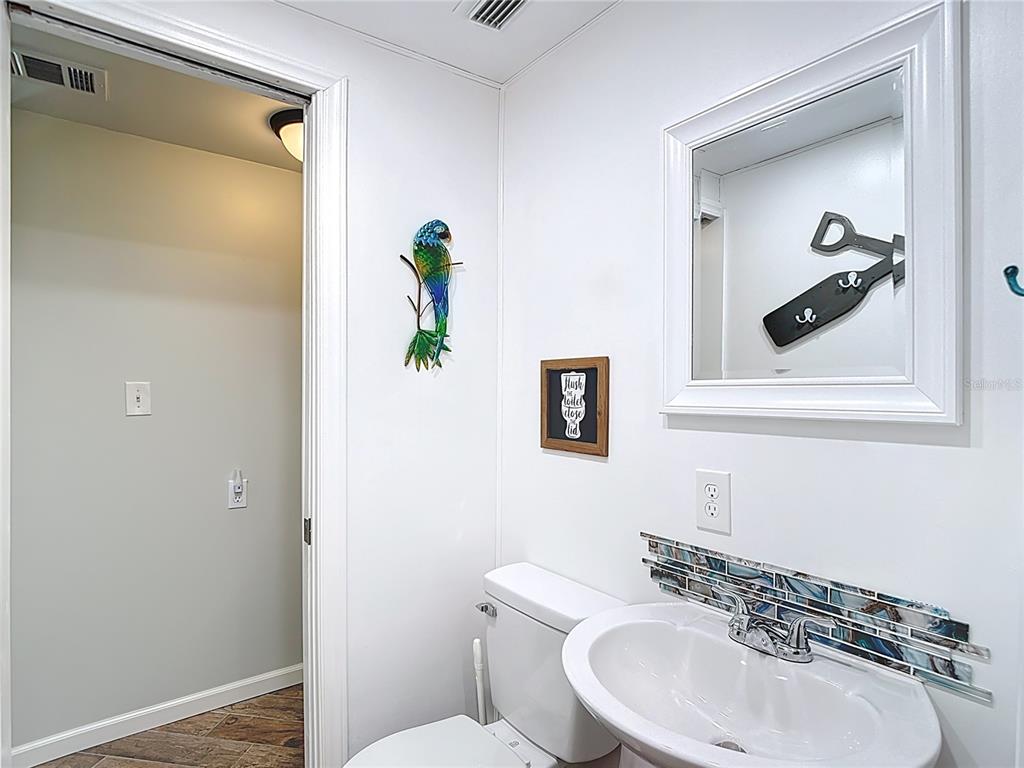 13607 Frances Avenue Hudson, FL 34667 - Photo 36 of 76 a bathroom with a sink and mirror with toilet