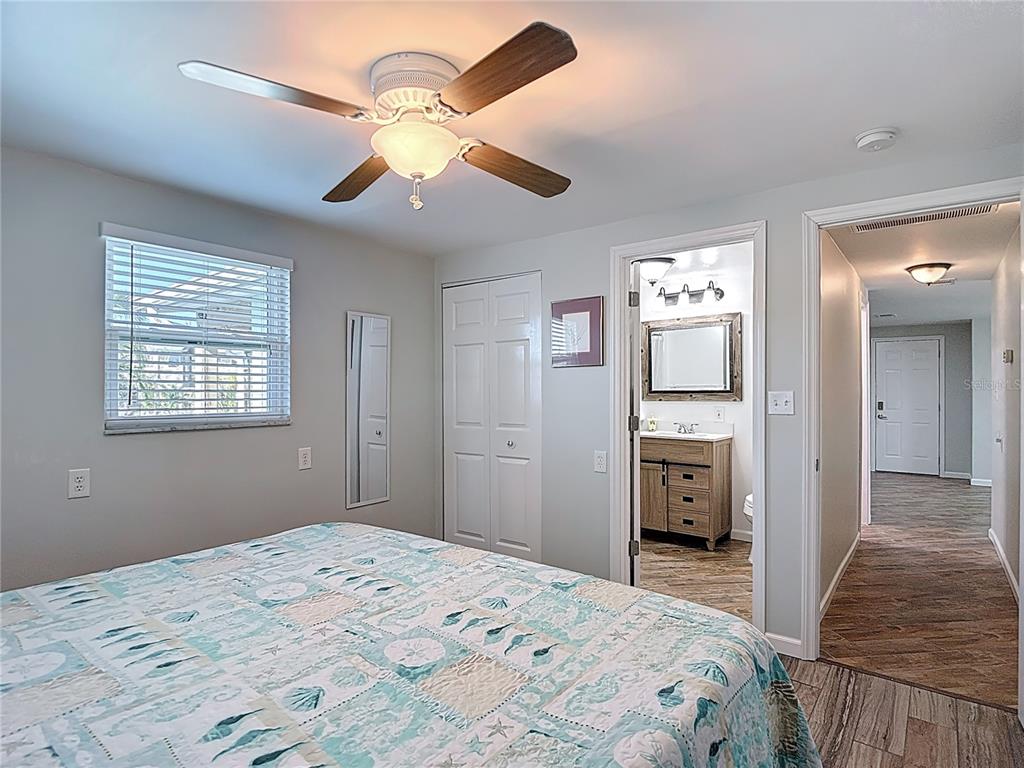 13607 Frances Avenue Hudson, FL 34667 - Photo 37 of 76 a bedroom with a bed and a chandelier