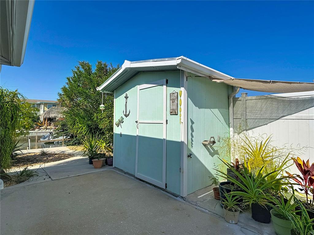 13607 Frances Avenue Hudson, FL 34667 - Photo 56 of 76 a yellow house with trees in front of it