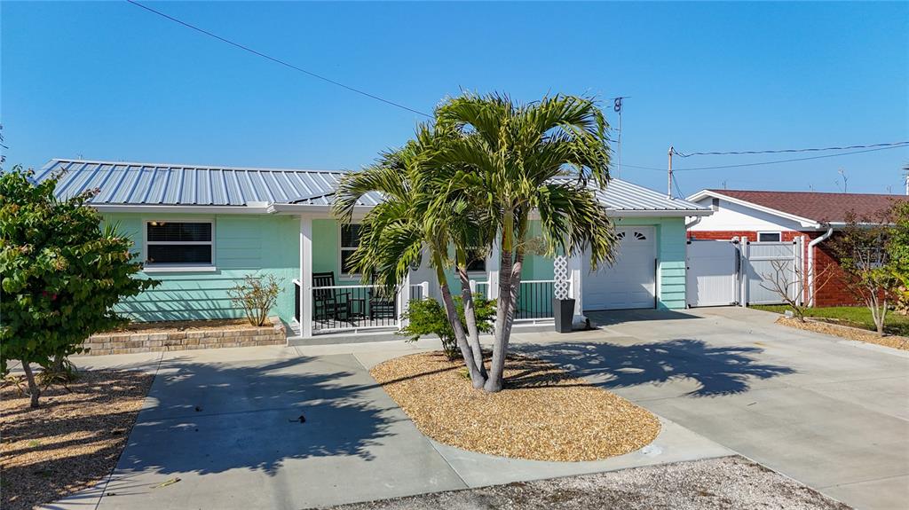 13607 Frances Avenue Hudson, FL 34667 - Photo 70 of 76 front view of a house with potted plants and palm trees