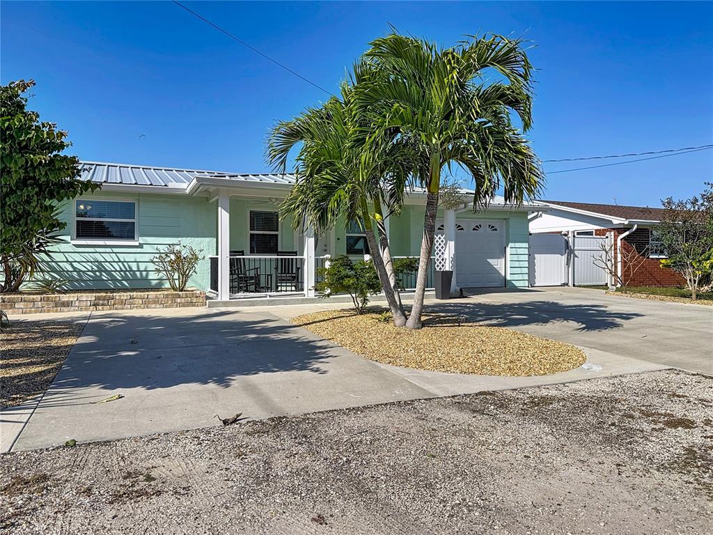 13607 Frances Avenue Hudson, FL 34667 - Photo 73 of 76 a view of a house with a snow yard and palm trees