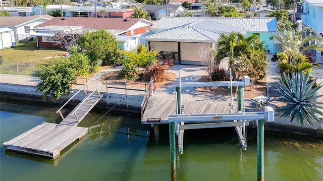 a living room with furniture kitchen view and a flat screen tv