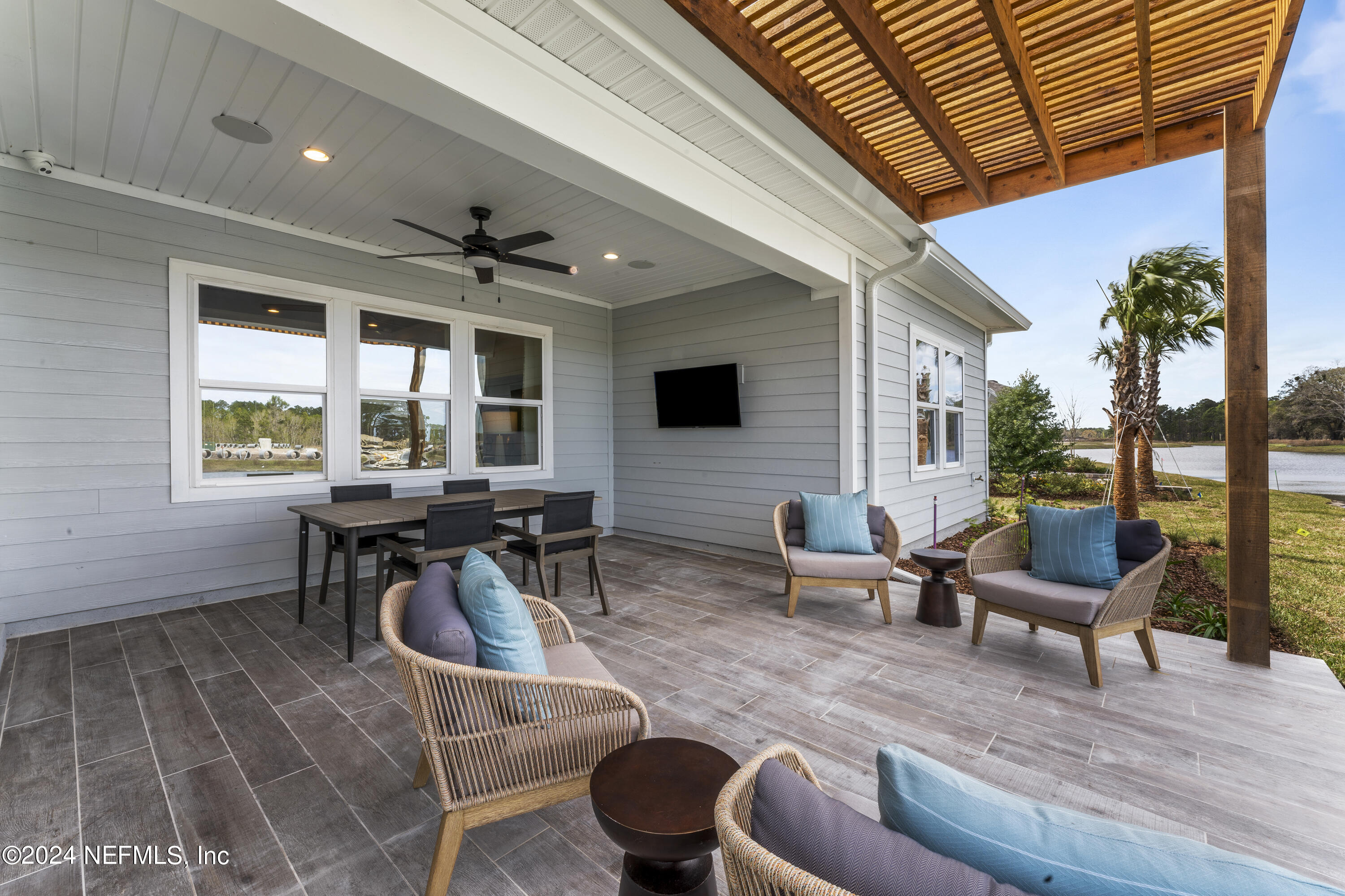 34 Natureland Circle St. Augustine, FL 32092 - Photo 3 of 26 a living room with furniture a flat screen tv and a large window