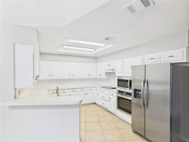 a kitchen with stainless steel appliances cabinets a sink and a counter top space