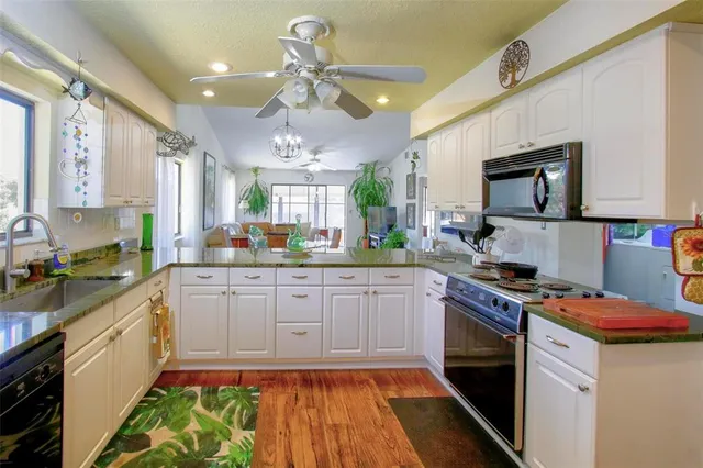 a kitchen with a stove a sink and a refrigerator