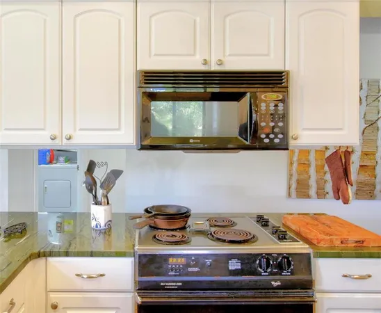 a kitchen with a stove and cabinets