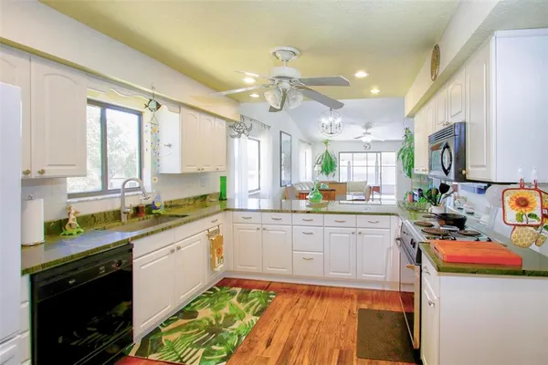 a kitchen with a sink cabinets and window