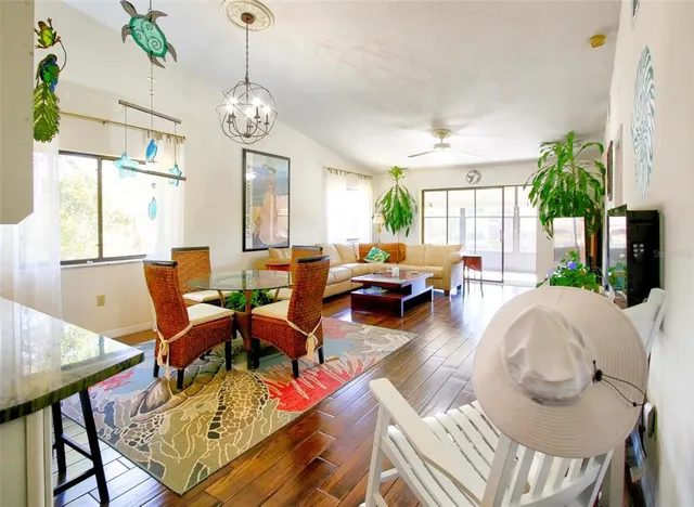 a living room with furniture chandelier and a fireplace