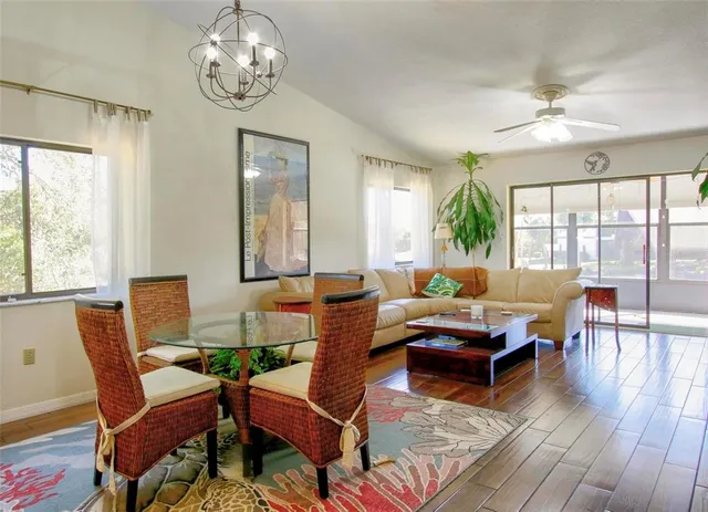 a living room with fireplace furniture and a large window