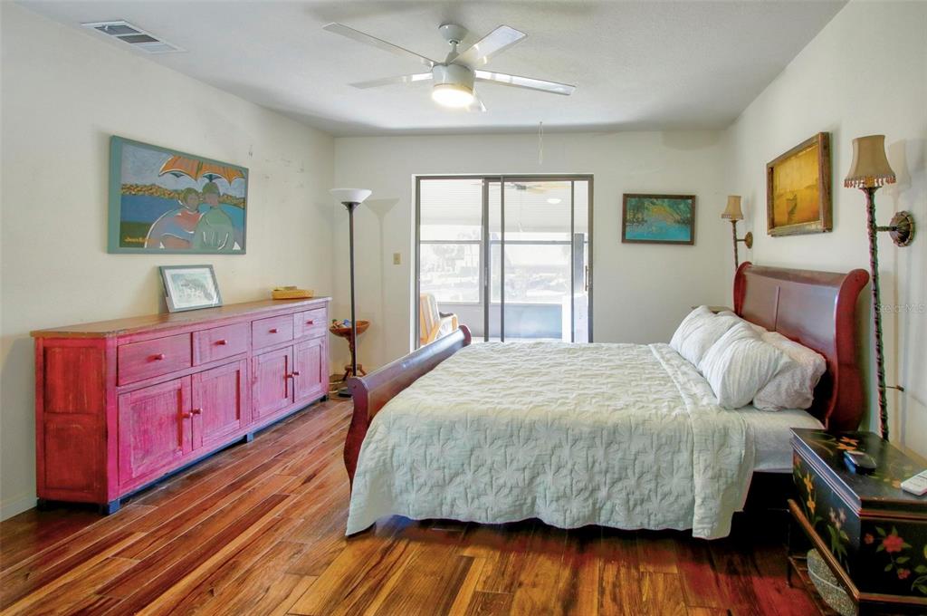 6502 River Run Boulevard, Unit 6502 Weeki Wachee, FL 34607 - Photo 26 of 47 a bedroom with a bed and wooden floor