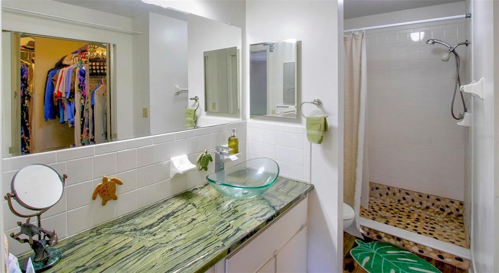 6502 River Run Boulevard, Unit 6502 Weeki Wachee, FL 34607 - Photo 29 of 47 a bathroom with a granite countertop sink and a mirror