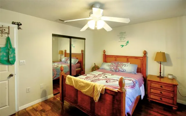 a bedroom with a bed and a chandelier