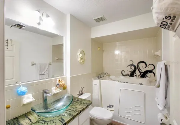 a bathroom with a sink a toilet and a mirror