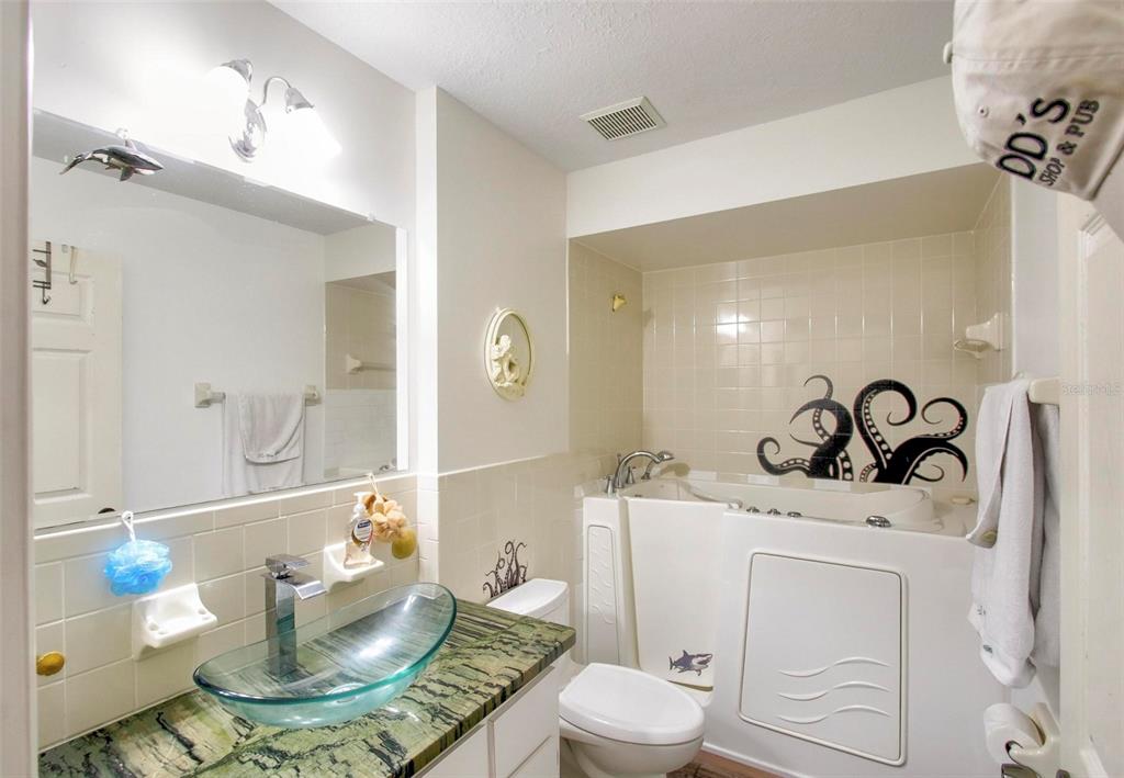 6502 River Run Boulevard, Unit 6502 Weeki Wachee, FL 34607 - Photo 34 of 47 a bathroom with a sink a toilet and a mirror