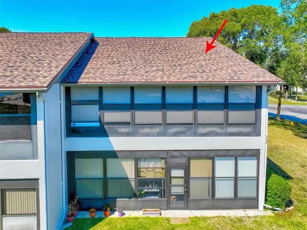a front view of a house with a yard balcony