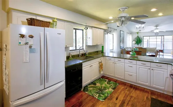 a kitchen with a refrigerator a sink and cabinets