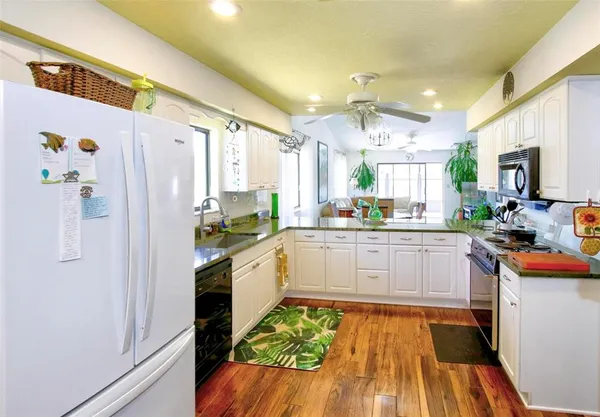a kitchen with stainless steel appliances a refrigerator and a stove top oven