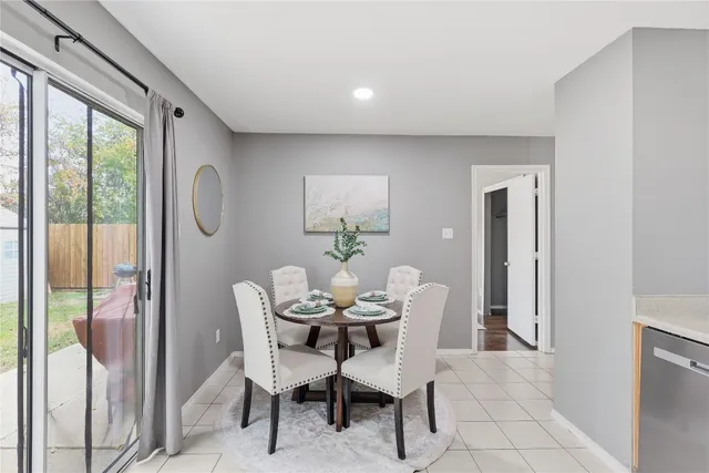 a dining room with furniture and window