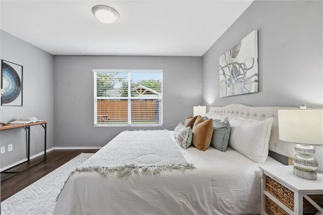 a bedroom with a bed and a painting on the wall