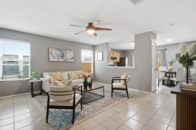 a living room with furniture a dining table and a fireplace