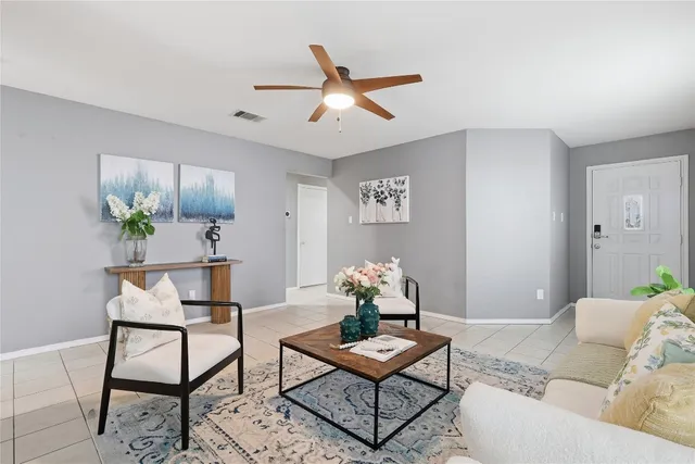 a living room with furniture and kitchen view