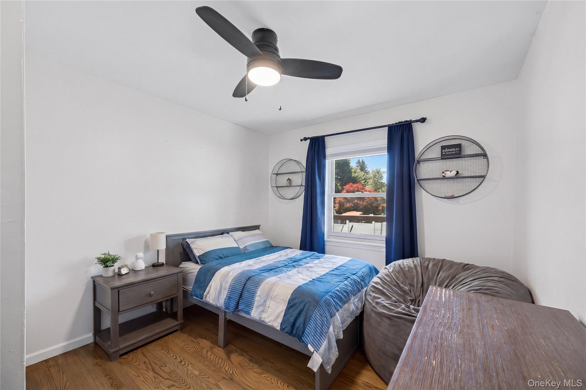 69 Silver Spring Road New Windsor, NY 12553 - Photo 14 of 20 a bedroom with a large bed and a chandelier