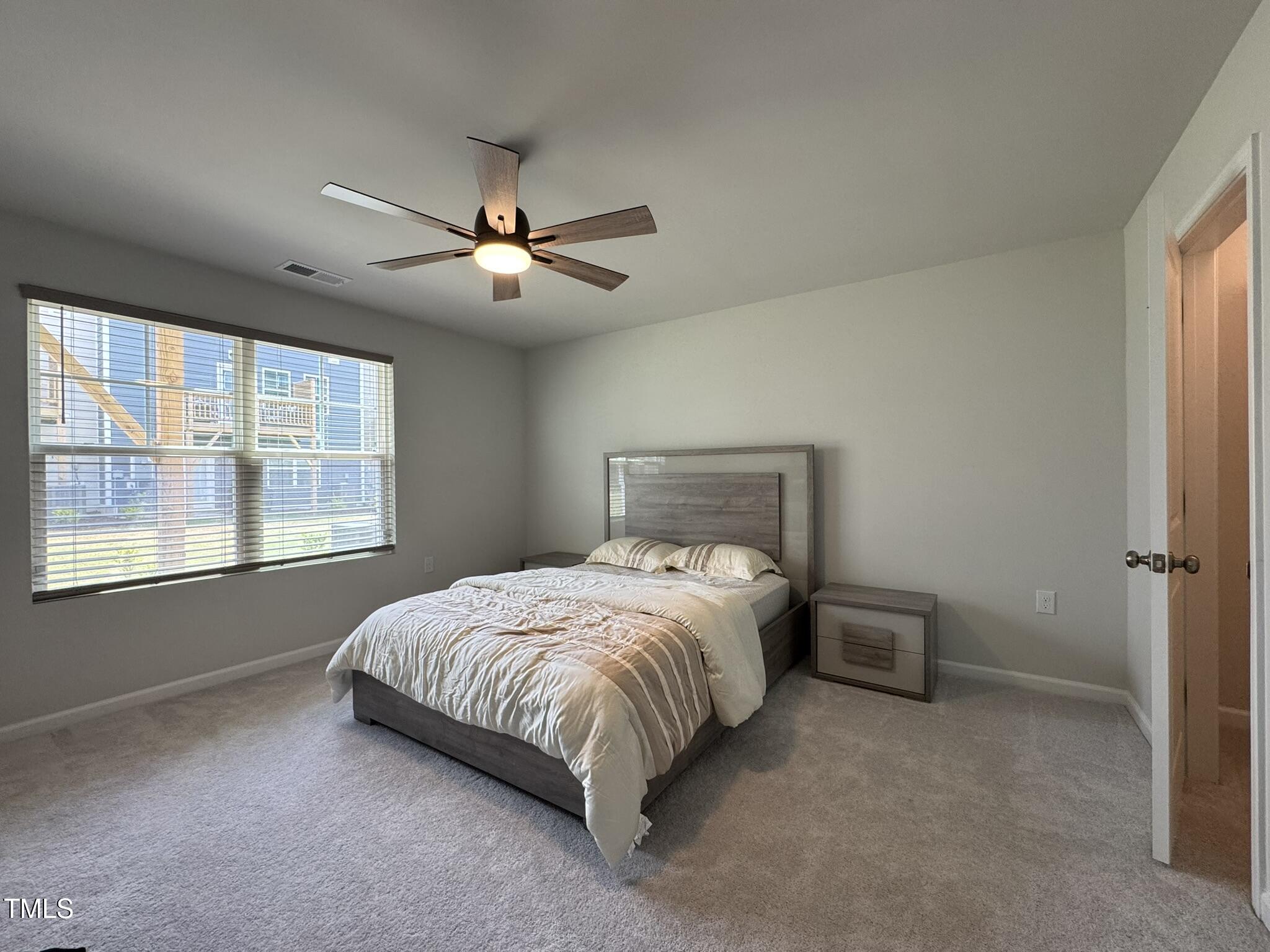 1106 Crossvine Trail Durham, NC 27703 - Photo 20 of 35 a bedroom with a bed and a window