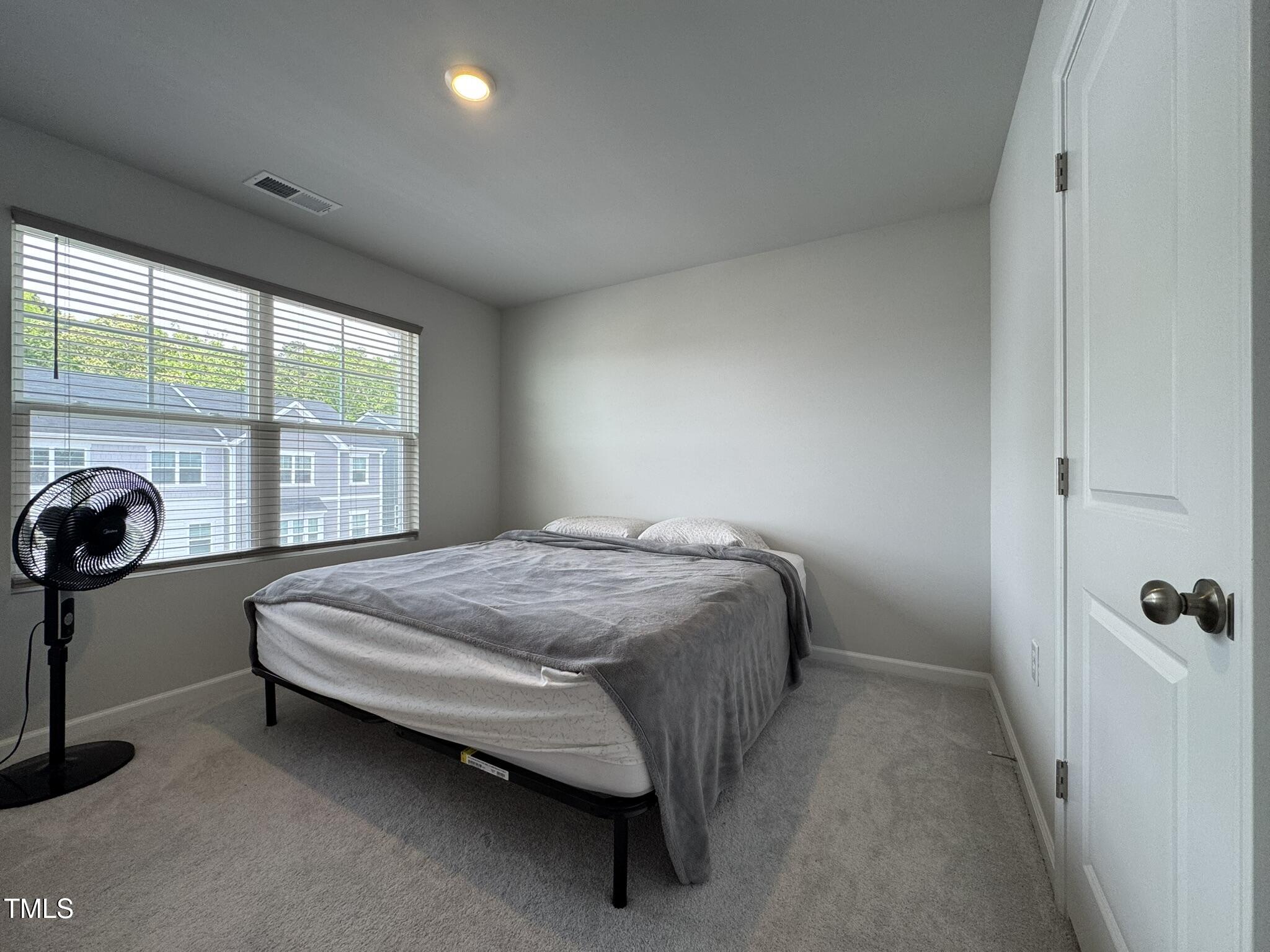1106 Crossvine Trail Durham, NC 27703 - Photo 34 of 35 a bed sitting in a bedroom next to a window