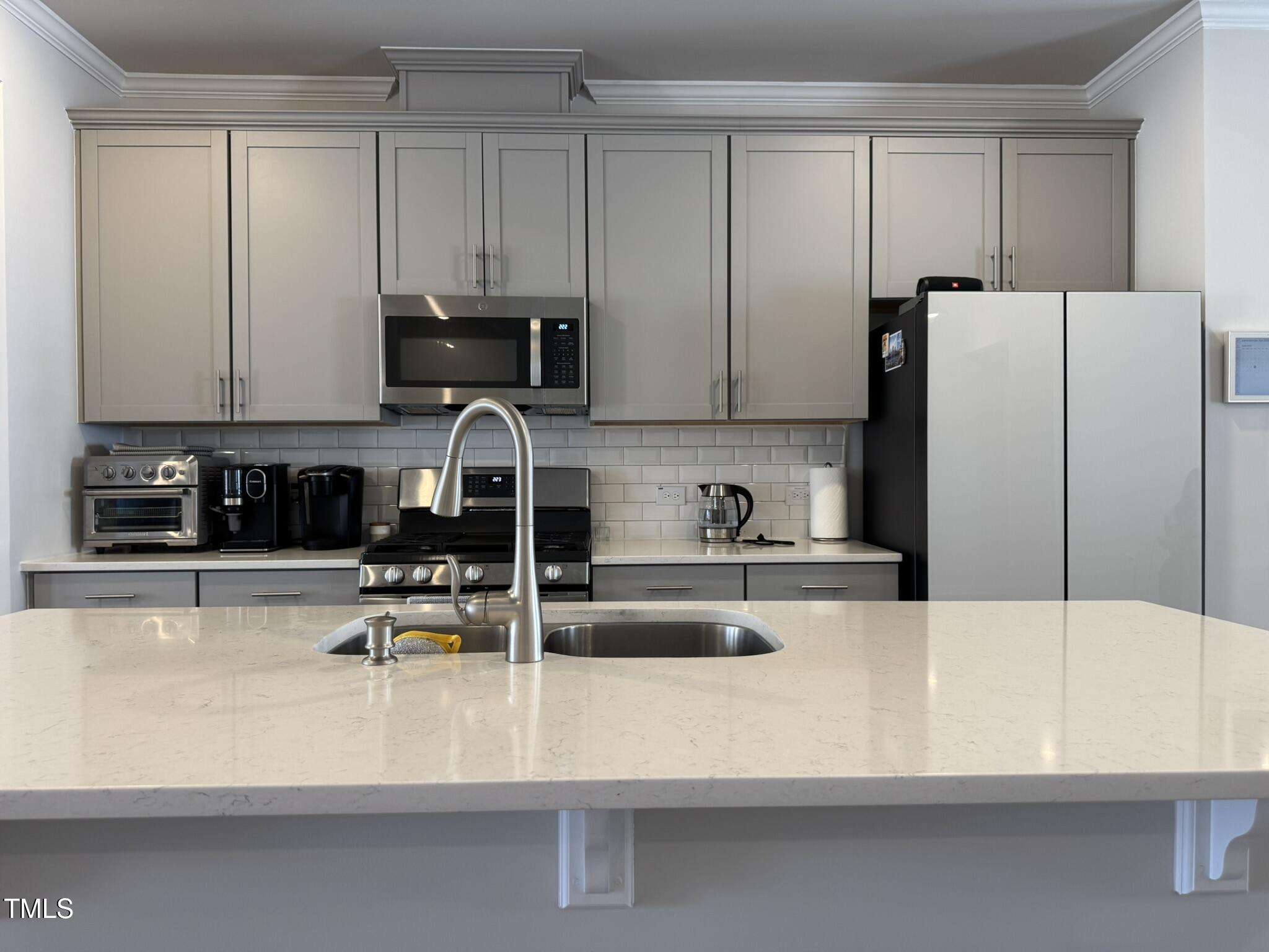 1106 Crossvine Trail Durham, NC 27703 - Photo 8 of 35 a kitchen with kitchen island a white counter top and cabinets