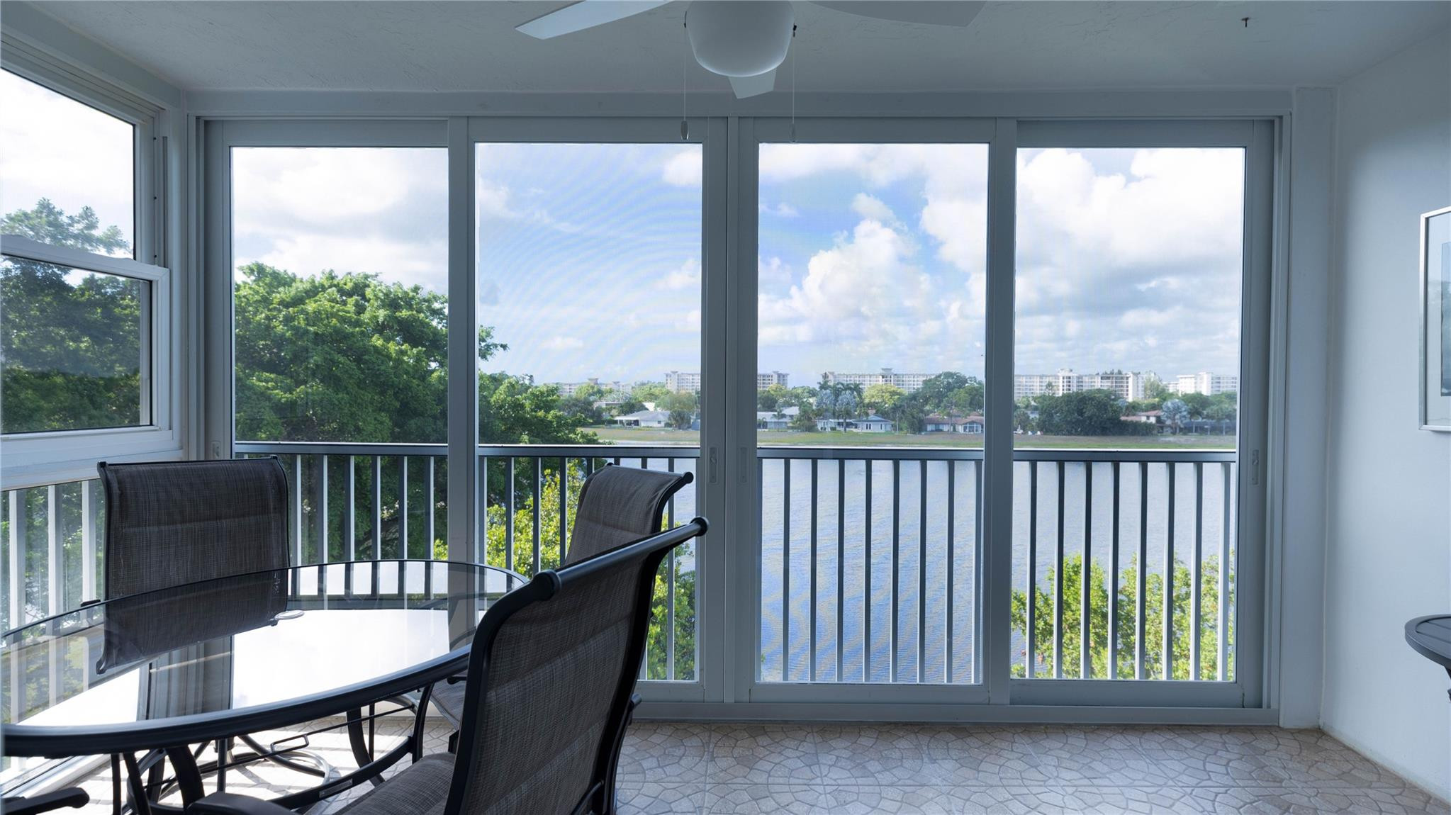 3100 North Course Lane, Unit 510 Pompano Beach, FL 33069 - Photo 20 of 23 a view of a balcony with furniture and wooden floor