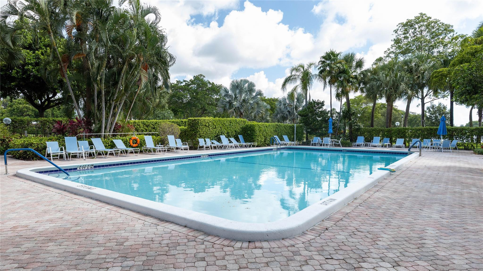3100 North Course Lane, Unit 510 Pompano Beach, FL 33069 - Photo 22 of 23 a view of a swimming pool with a sitting space