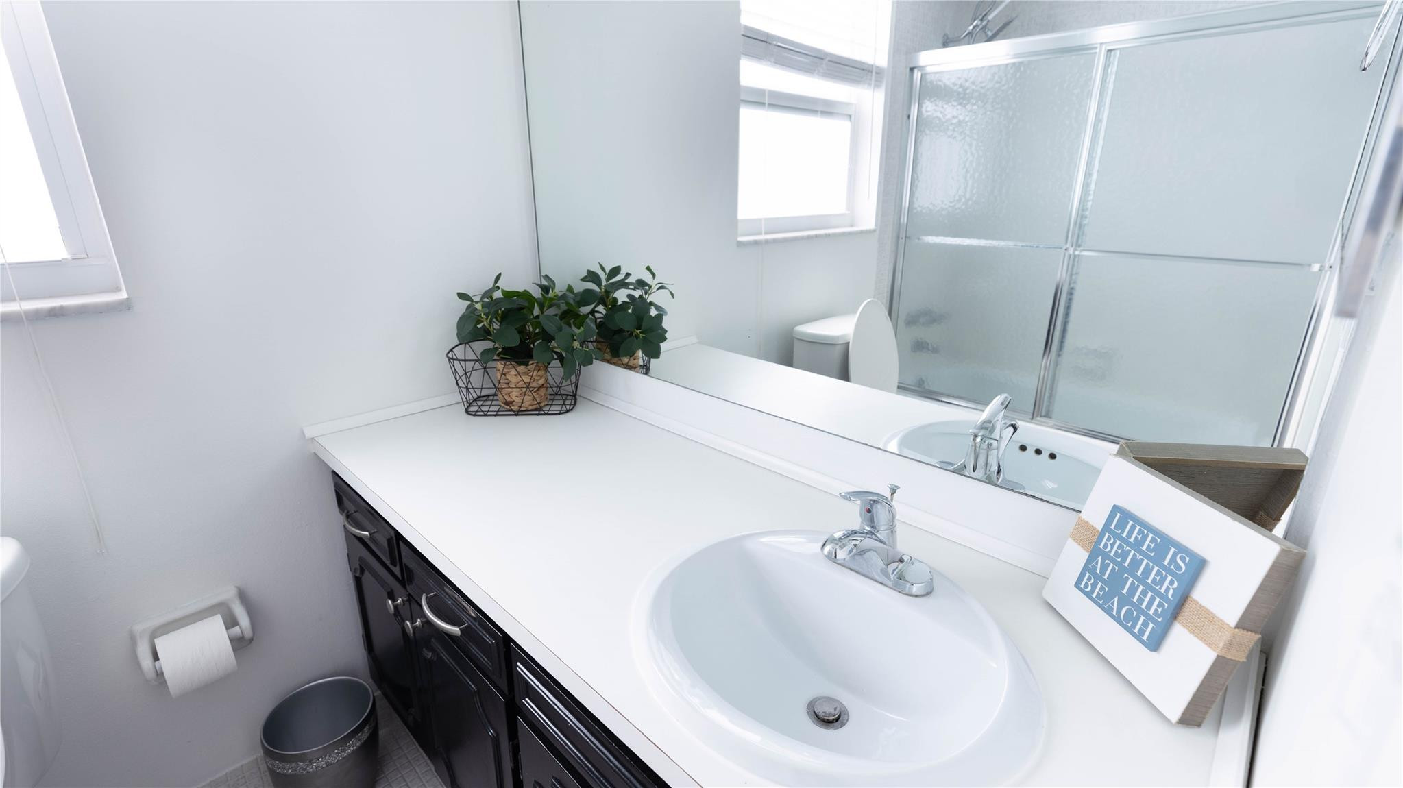 3100 North Course Lane, Unit 510 Pompano Beach, FL 33069 - Photo 3 of 23 a bathroom with a sink a toilet and mirror