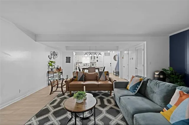 a living room with furniture and a dining table