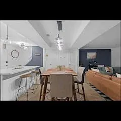 a view of a dining room with furniture and chandelier