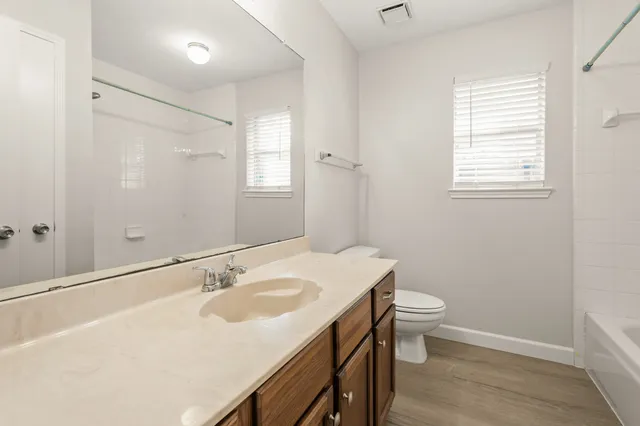 a bathroom with a sink toilet and vanity
