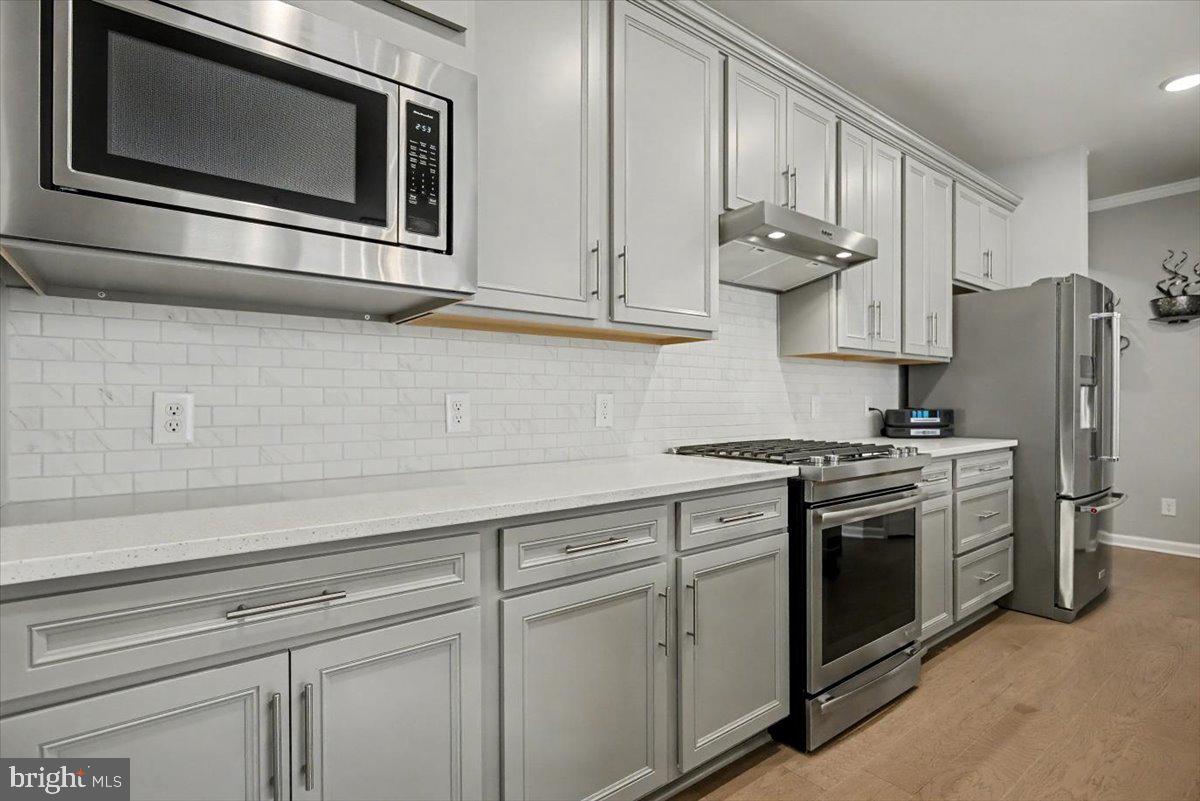 1165 Mason Road Hatfield, PA 19440 - Photo 11 of 33 a kitchen with stainless steel appliances granite countertop white cabinets and a stove top oven