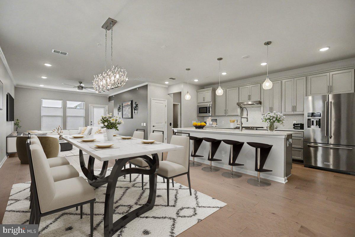 1165 Mason Road Hatfield, PA 19440 - Photo 12 of 33 a view of a dining room and livingroom with furniture wooden floor a chandelier