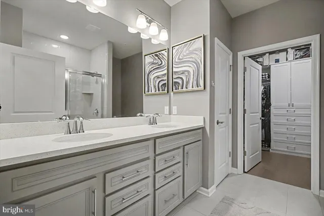 a spacious bathroom with a sink a mirror and a shower