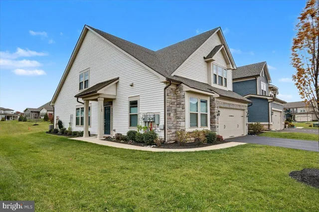 a front view of a house with a garden