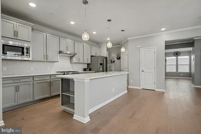a kitchen with cabinets and stainless steel appliances