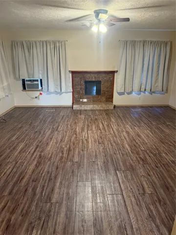 wooden floor fireplace and natural light in room