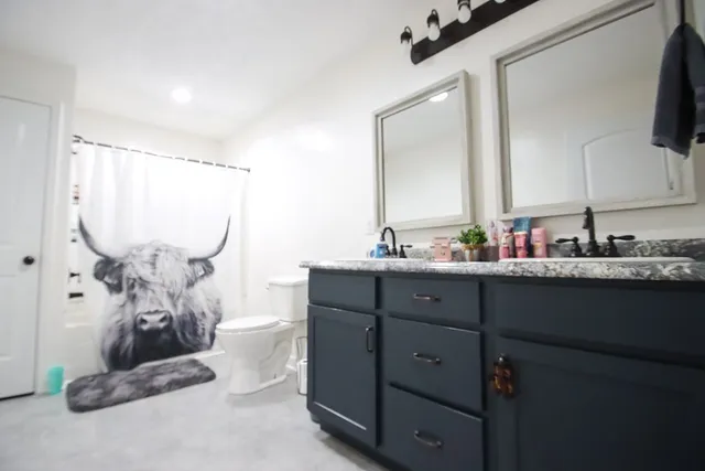 a bathroom with a double vanity sink and a mirror